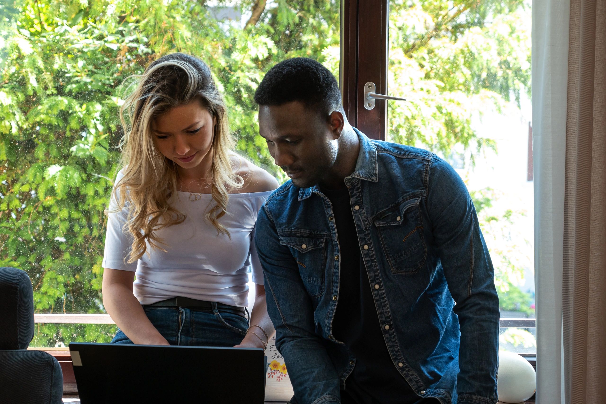 Couple reviewing documents together on a laptop